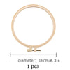 A circular, light beige embroidery hoop with a threaded base for hand embroidery stitches.