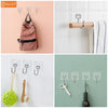 A collection of heavy duty adhesive hooks and a wooden hanger shown against a white background.