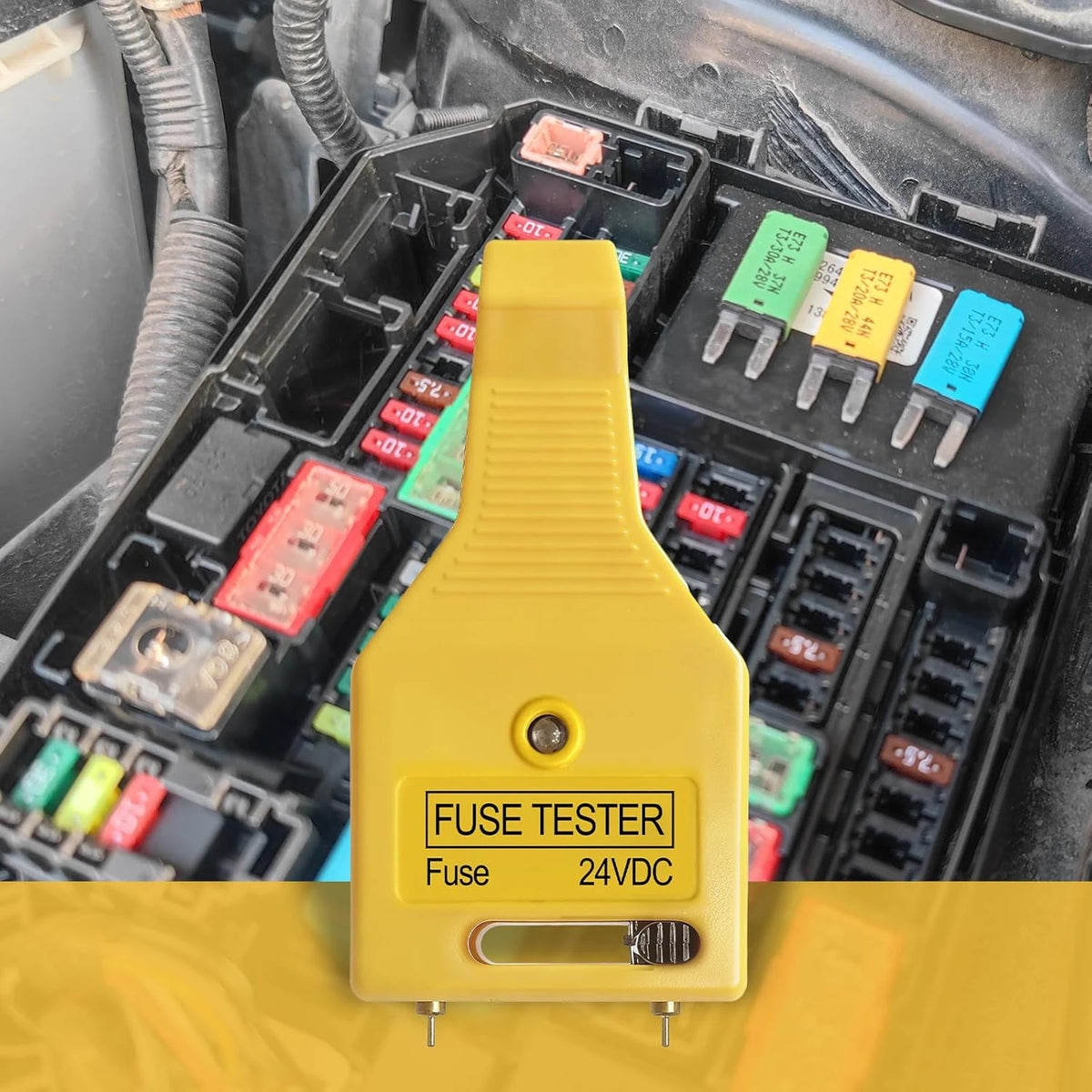 A yellow automotive fuse tester tool is shown inserted into a black fuse box with various fuses and relays.