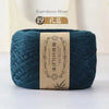 A ball of dark teal bamboo fiber yarn labeled as 19 扎蓝, ready for knitting or crochet.