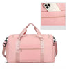 A pink large capacity travel duffel bag with a zippered compartment and a shoe section.