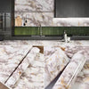 Rolls of marble contact paper featuring white and gold veining for kitchen and furniture decoration