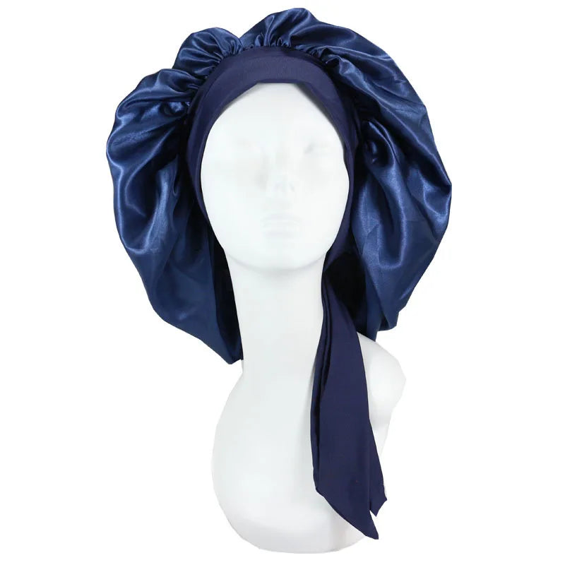 A navy blue satin sleep cap draped over a white mannequin head.