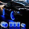 A set of ten glow-in-the-dark blue tire valve caps displayed on a reflective surface.