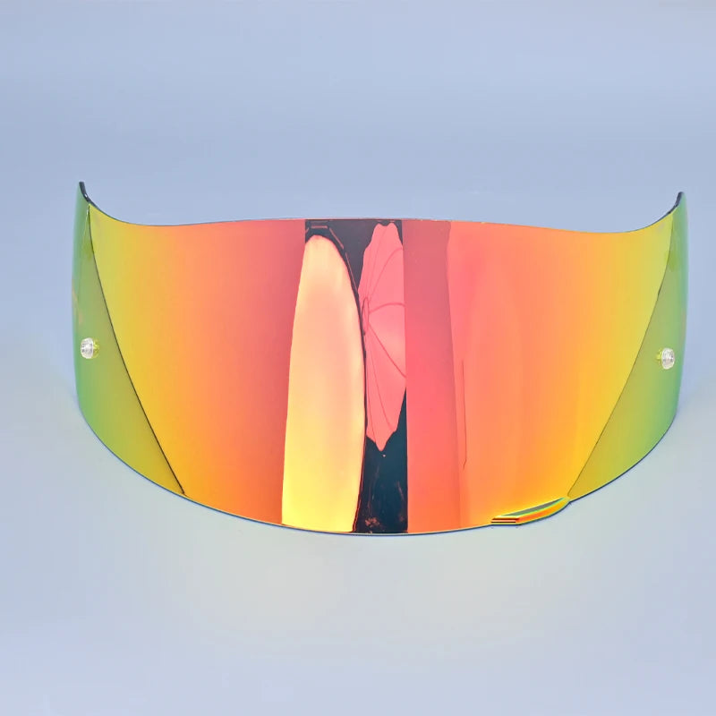 A curved, tinted visor lens shield for a motorcycle helmet, displaying an orange-to-green gradient.
