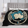 A black throw blanket featuring a graphic of a sleeping Snorlax face in teal and cream colors.