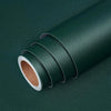 A roll of dark green self-adhesive peel-and-stick wallpaper shown diagonally on a dark surface.