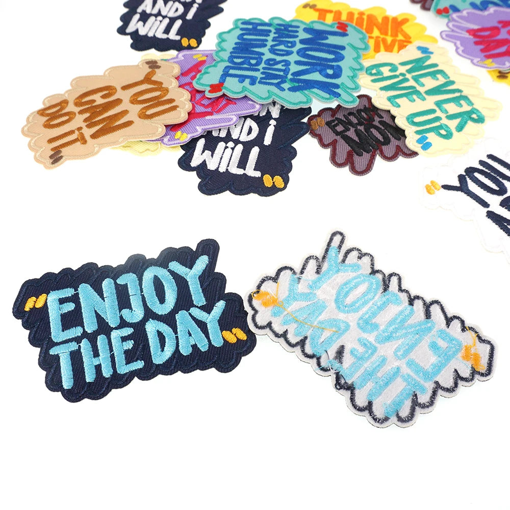 A collection of colorful embroidered iron-on patches featuring motivational and humorous text like I Will You Can It Think Ne