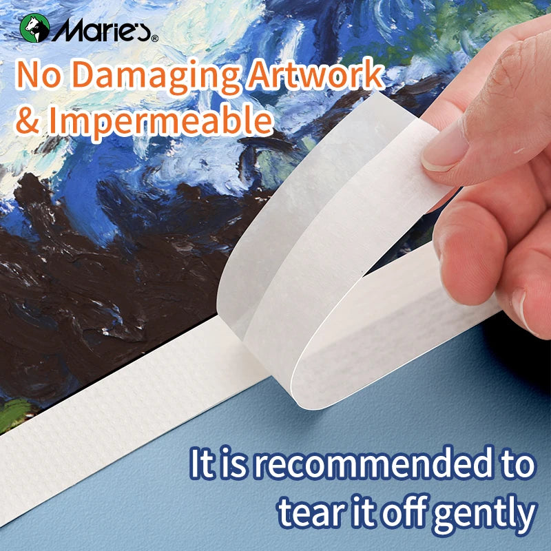 A hand is gently tearing off a piece of white decorative paper tape for use in art projects.