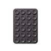 A black silicone suction pad with multiple circular indentations for phone mounts.