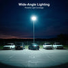 Wide-angle lighting illuminating a parking lot at night with a bright street lamp above.