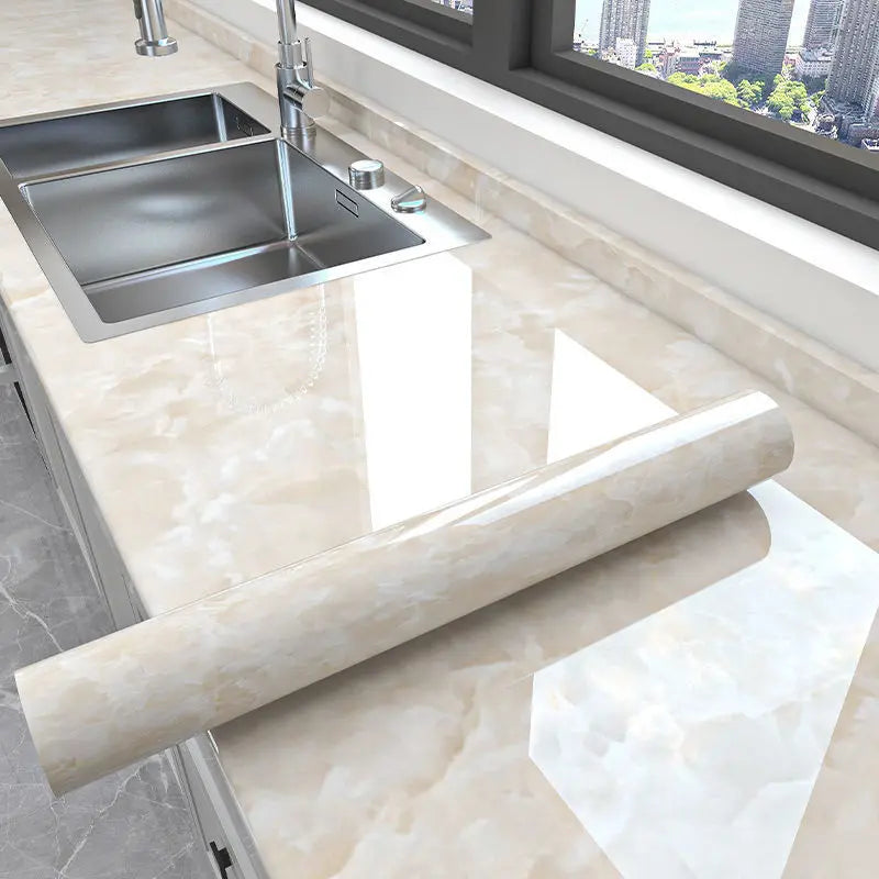 Marble peel-and-stick wallpaper used as a decorative element on a kitchen countertop.