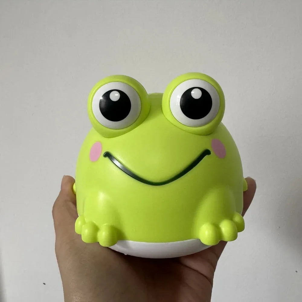 A bright lime green rubber toy shaped like a frog with large eyes and a smile, held in a person's hand.