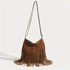 A brown bohemian fringe shoulder bag with long leather straps hanging down
