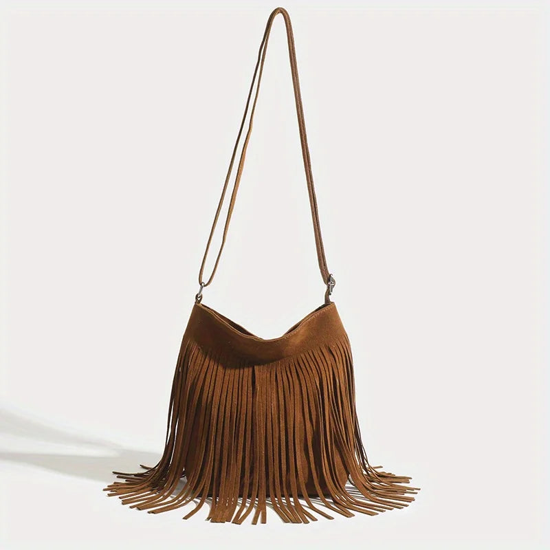 A brown bohemian fringe shoulder bag with long leather straps hanging down