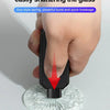 A hand presses a black firing pin into a piece of glass to shatter it, demonstrating the emergency car safety hammer's functi