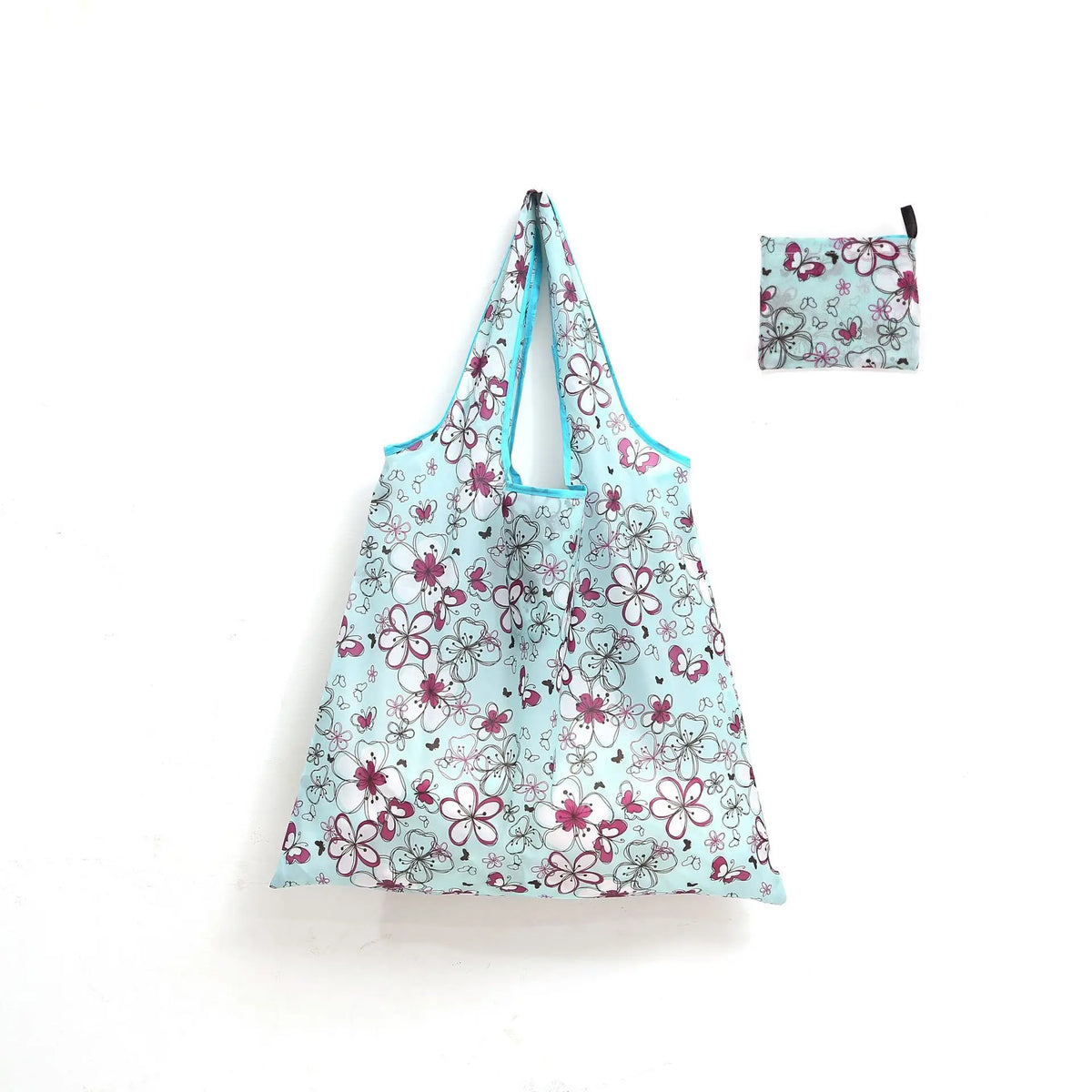 A light blue floral reusable shopping tote bag with a matching small carry pouch.