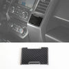Black carbon fiber grain trim cover for a Ford F-150 center console.