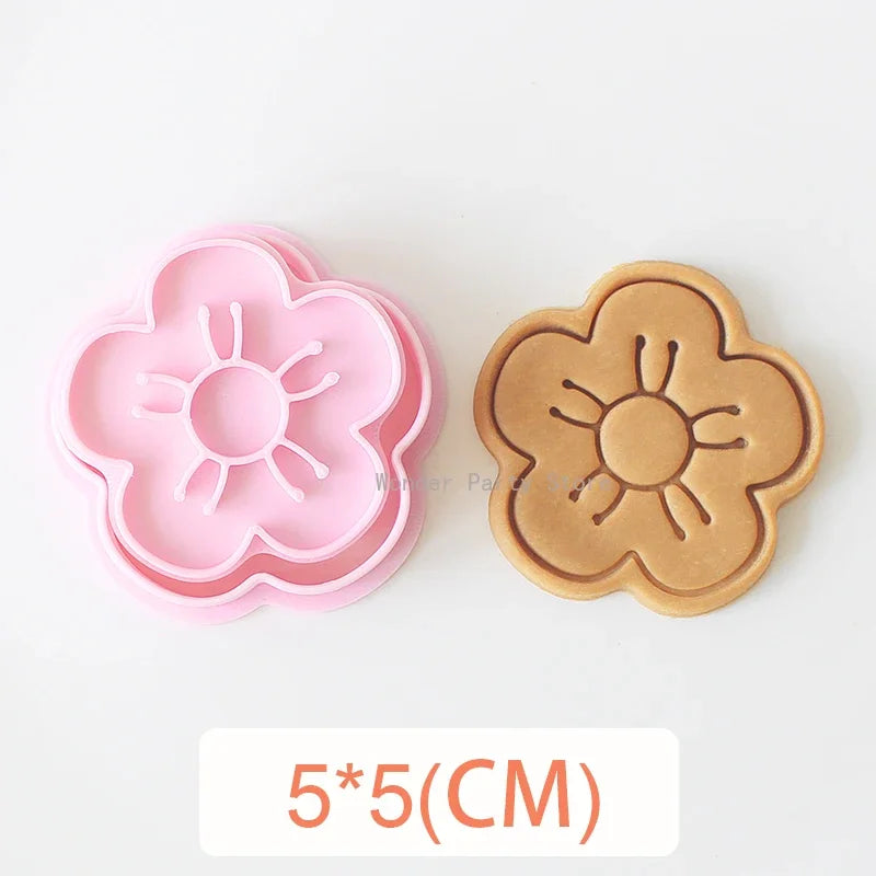 A set of three silicone cookie cutters featuring floral designs including cherry blossom, peach blossom, and sunflower shapes