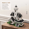 A detailed model of a Victorian house built from white bricks and accessories, displayed on a wooden surface.