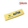 A yellow salted butter fidget stick measuring 14cm long.