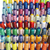 A display of various multi-colored polyester embroidery threads in spools arranged horizontally.