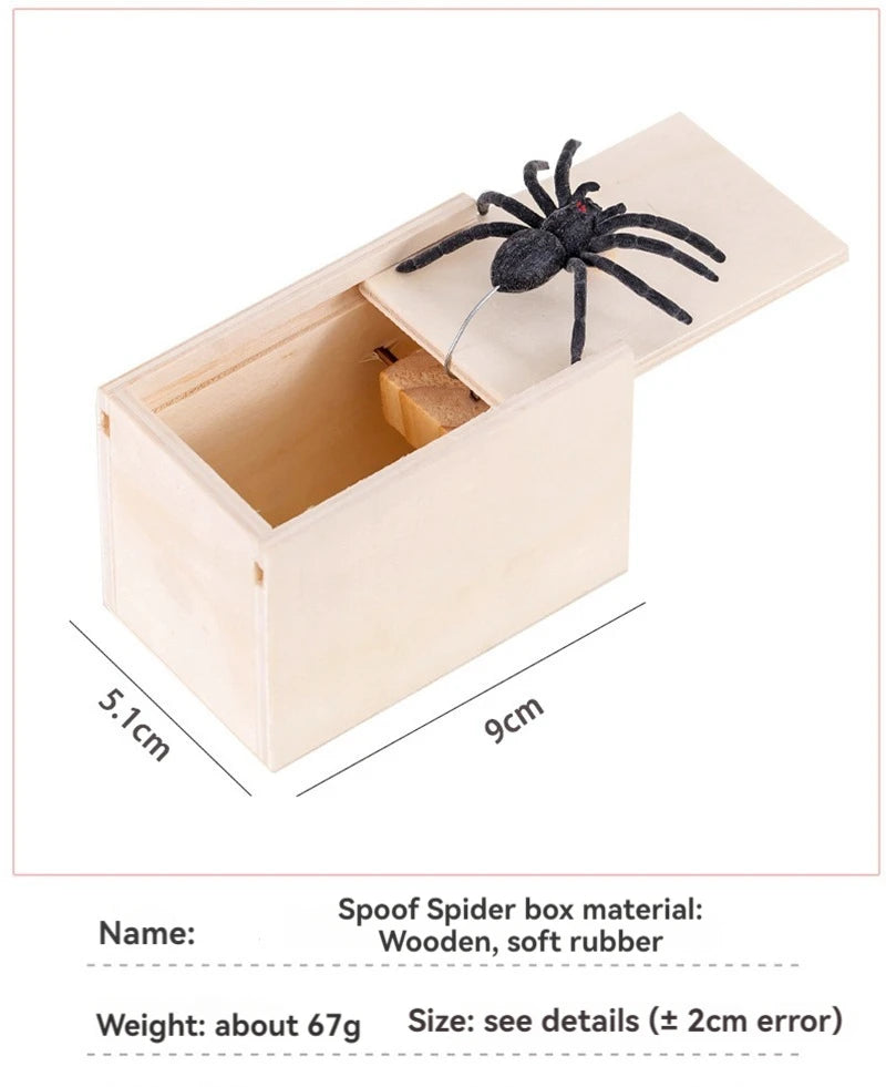 A wooden box containing a black spider model, made of wood and soft rubber.