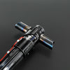 A close-up view of a black metal lightsaber with a blue hilt and red accents, showing motion control components.