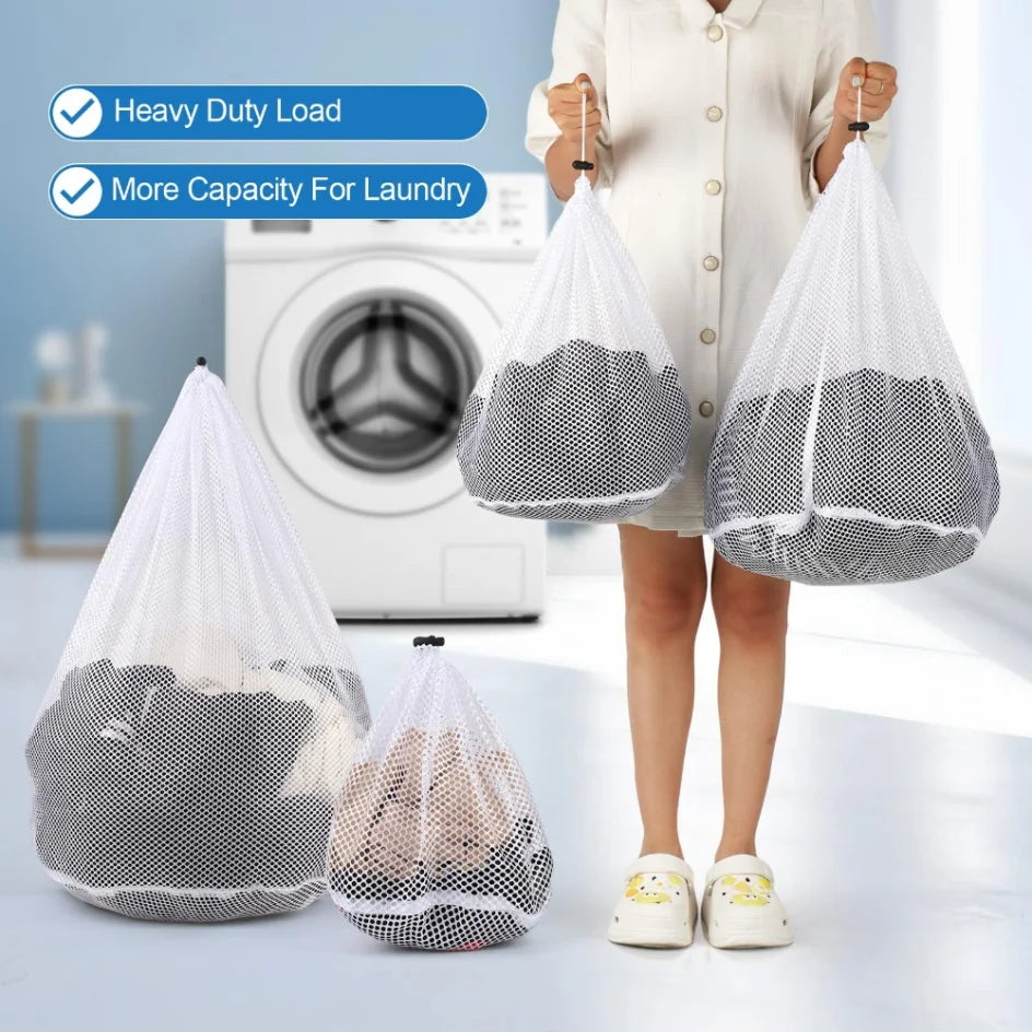 A person holds two large mesh laundry bags while a washing machine is visible in the background.