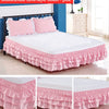Monochrome three-layer pink bed skirt wrapping around a bed, shown in a bedroom setting.