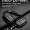 A black genuine leather car key holder featuring a key and a separate key cover is displayed on a dark surface.