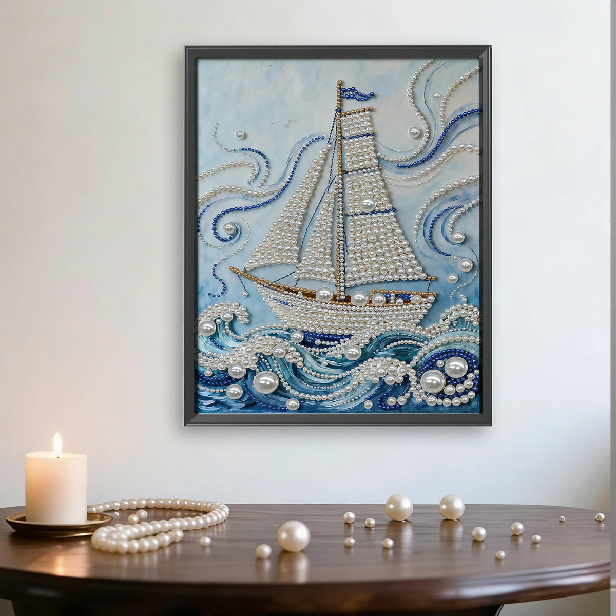 A framed painting depicting a sailboat made of pearls on blue water against a light blue background.