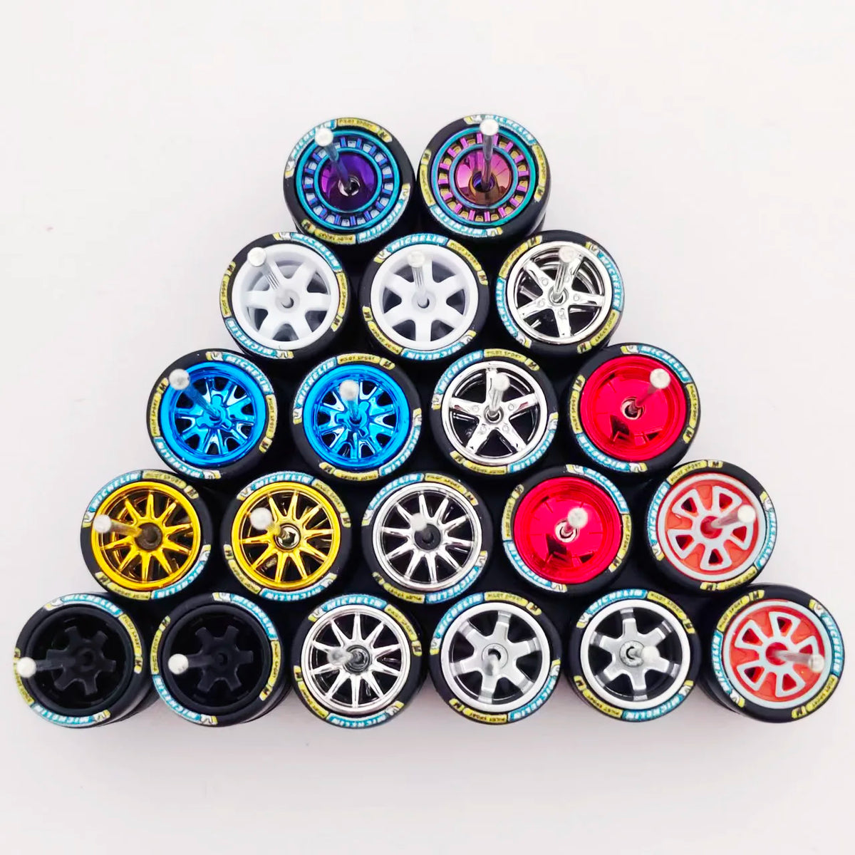 A collection of ten 1:64 scale alloy car wheels and tires arranged in a pyramid formation.