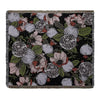 A dark floral pattern woven throw blanket featuring roses and leaves in muted pinks, greens, and whites.