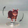 A small, dark brown tabby cat figure mounted on a clear acrylic base with rotating arrows.