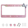 Pink rhinestone license plate frame with a silver accent bow and mounting hardware