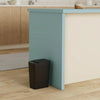 A modern, light blue kitchen island with a cream countertop and a dark trash can placed in front of it.
