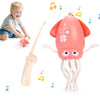 A pink interactive dancing squid toy with lights and tentacles is shown next to a small red obstacle toy and a light-colored 