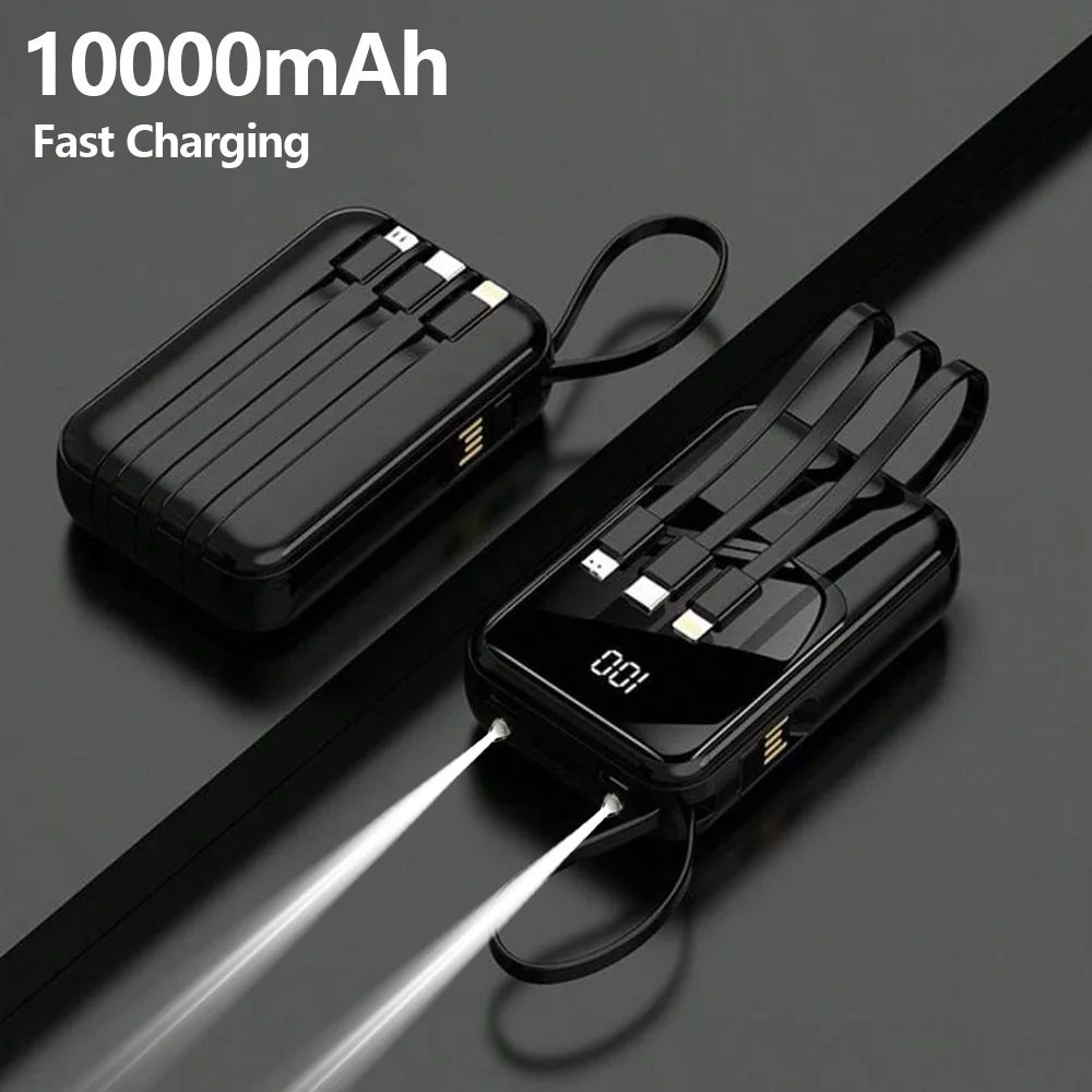 A black 10000mAh portable power bank with built-in cables and a flashlight is shown lying on a dark surface.