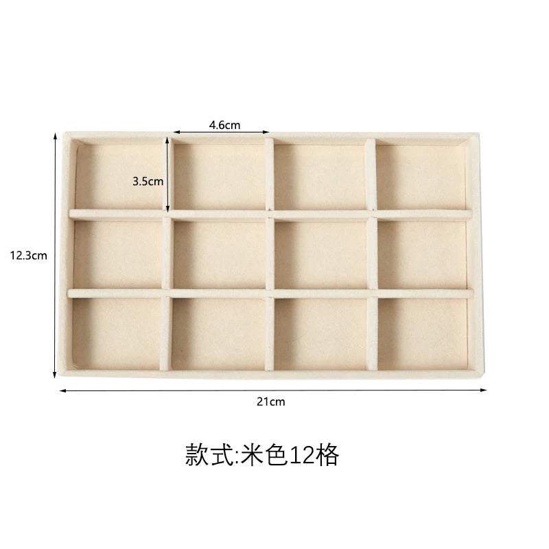 A rectangular velvet jewelry organizer tray with twelve detachable compartments.