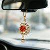 Gold-tone Islamic calligraphy pendant with a star and crescent design hanging from a chain, displayed in a car mirror.