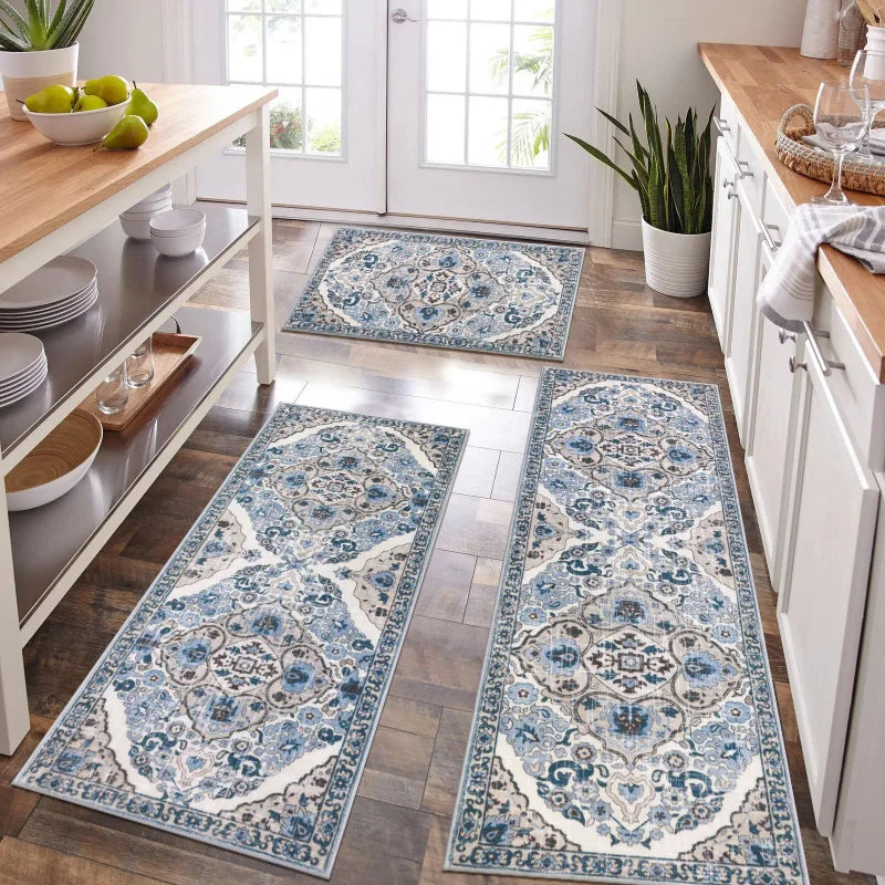 A long rectangular blue and white patterned kitchen rug placed on a wooden floor.