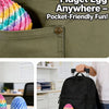A colorful twisty fidget egg is shown inside a green fabric pocket, next to a black backpack and suitcase.
