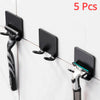 Five black aluminum wall-mounted adhesive razor holders displayed against a white tiled surface.