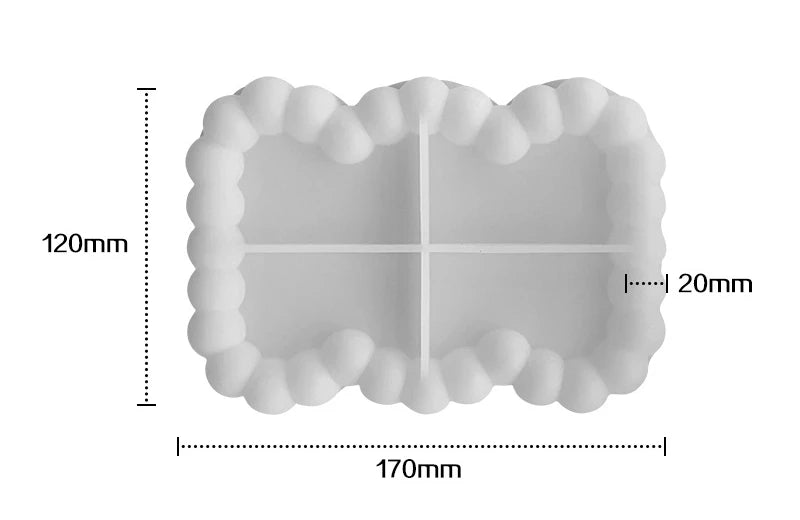 A silicone tray mold with a decorative, ruffled edge and a central cross-shaped depression for crafting materials.