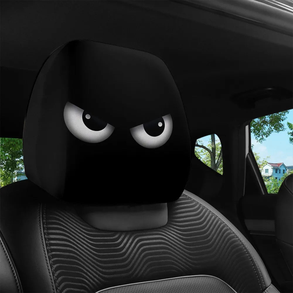 A black car headrest cover with slanted eyes design is visible inside a vehicle.