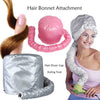 A woman is shown using a silver hair dryer cap and styling tool on her hair, with a pink hair bonnet attachment nearby.