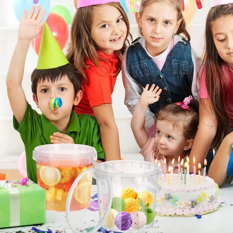 Children celebrating a birthday with a cake and colorful fruit in transparent reusable storage containers