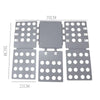A gray magic clothes folding board with a central panel and surrounding circular holes for organizing t-shirts.