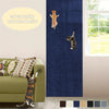 A dark blue self-adhesive cat scratching mat is installed on a wall, with a cat visible on the mat and another cat near furni
